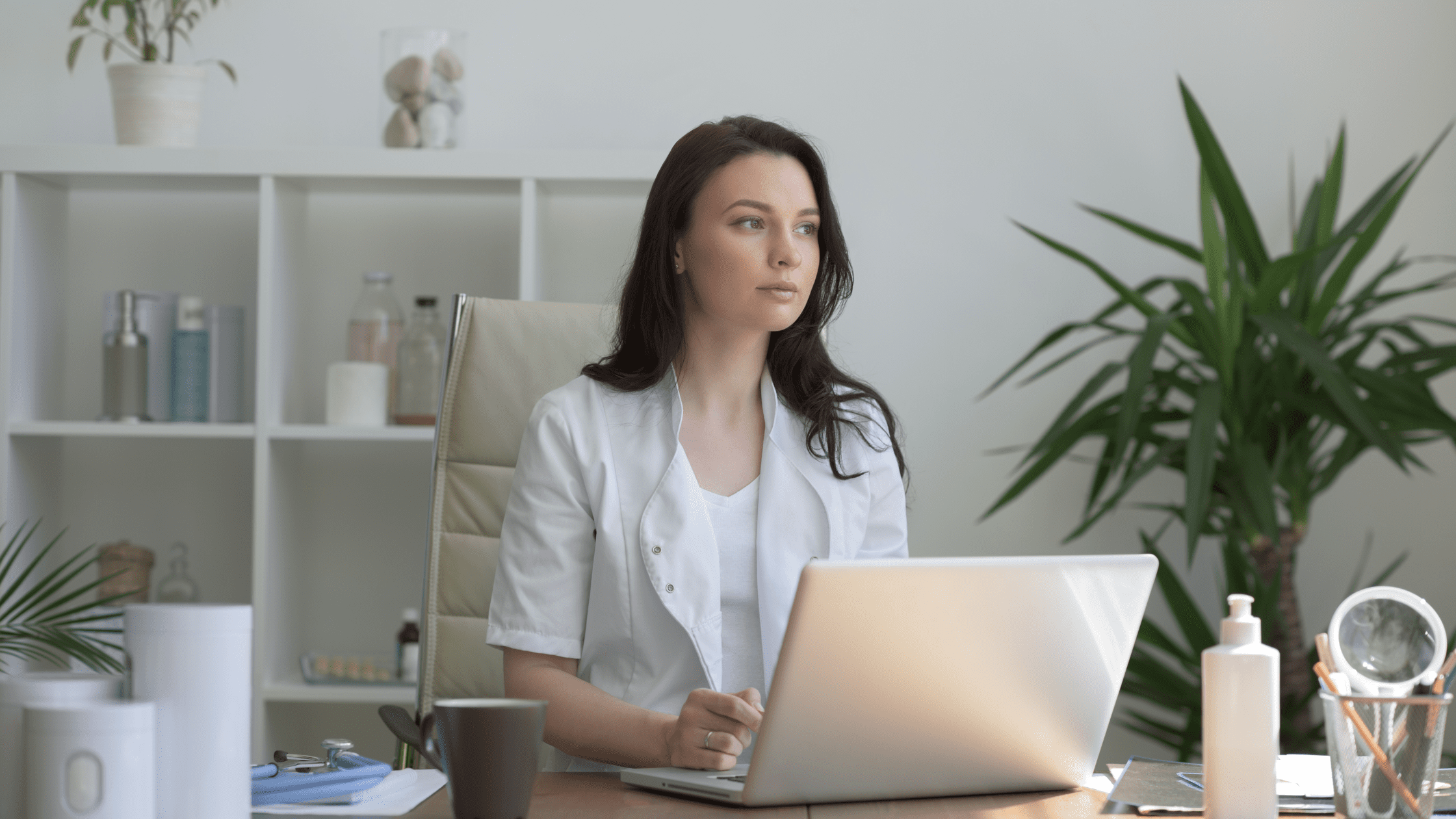 A prospective medical resident sitting in front of a laptop, planning her ERAS application and program selection.